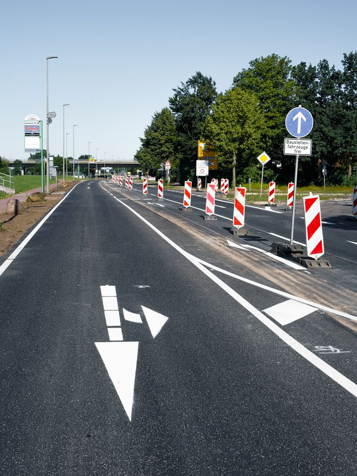 Paved road under construction with safety signs in Geesthacht, Germany.